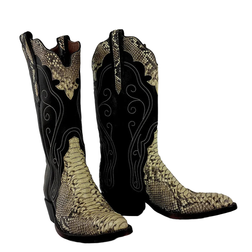 A pair of tall western cowboy boots featuring a black shaft with white scrollwork embroidery and a beige and black snakeskin pattern on the foot, set against a plain gray background.
