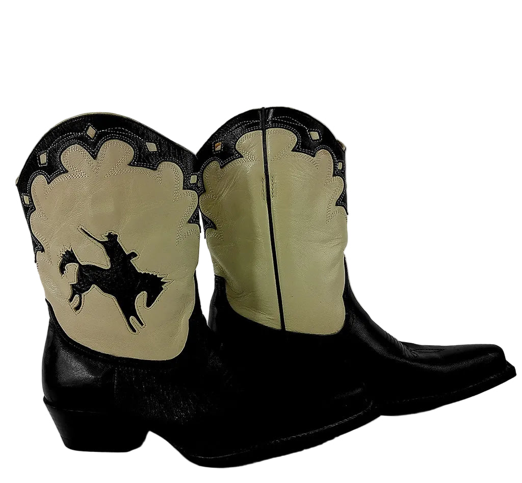 A pair of black leather cowboy boots with cream-colored western shaft panels featuring a black silhouette of a rider on a bucking horse.