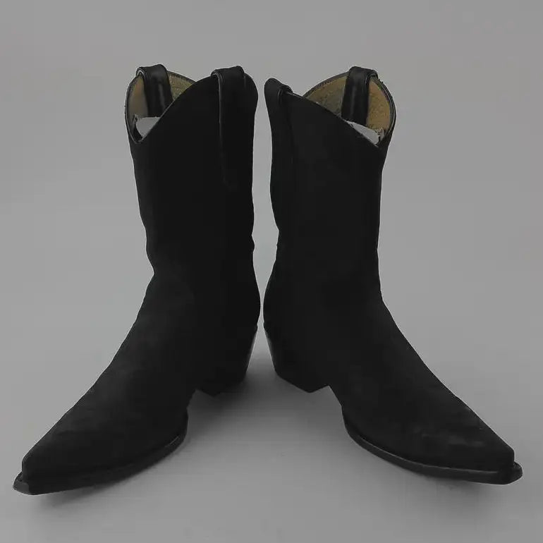 A pair of black pointed-toe western boots with a suede-like finish, photographed against a neutral gray background.