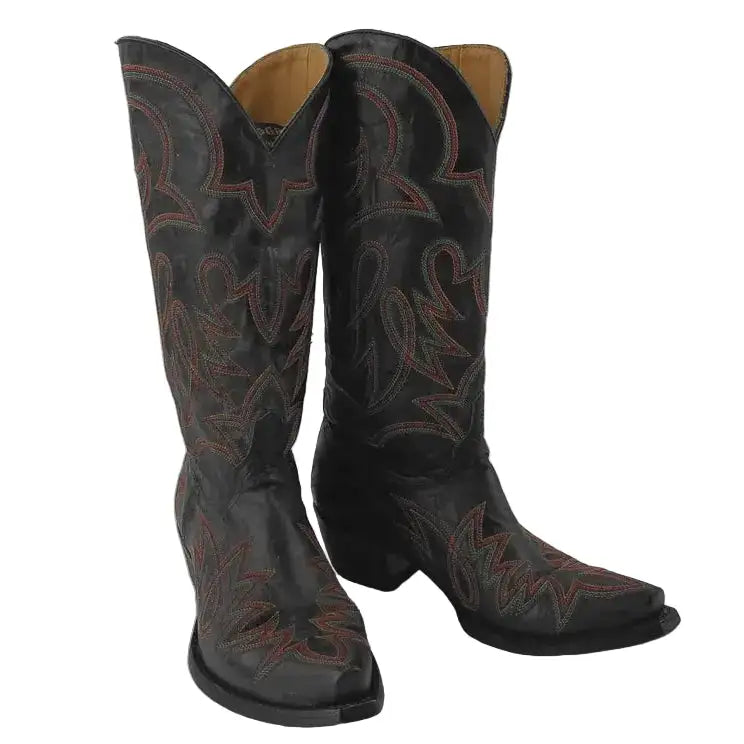 A pair of black leather cowboy boots with orange embroidered western patterns, shown against a neutral gray background.