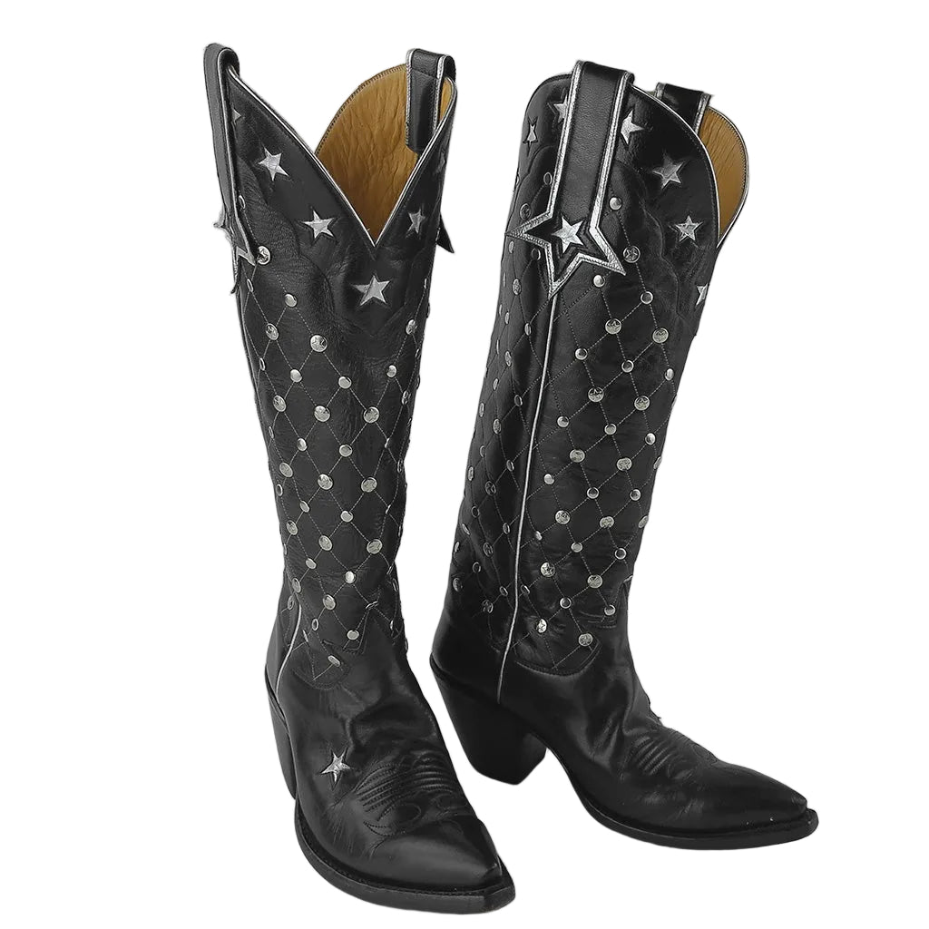 A pair of black leather knee-high cowboy boots with silver star and dot embellishments, shown against a neutral gray background.