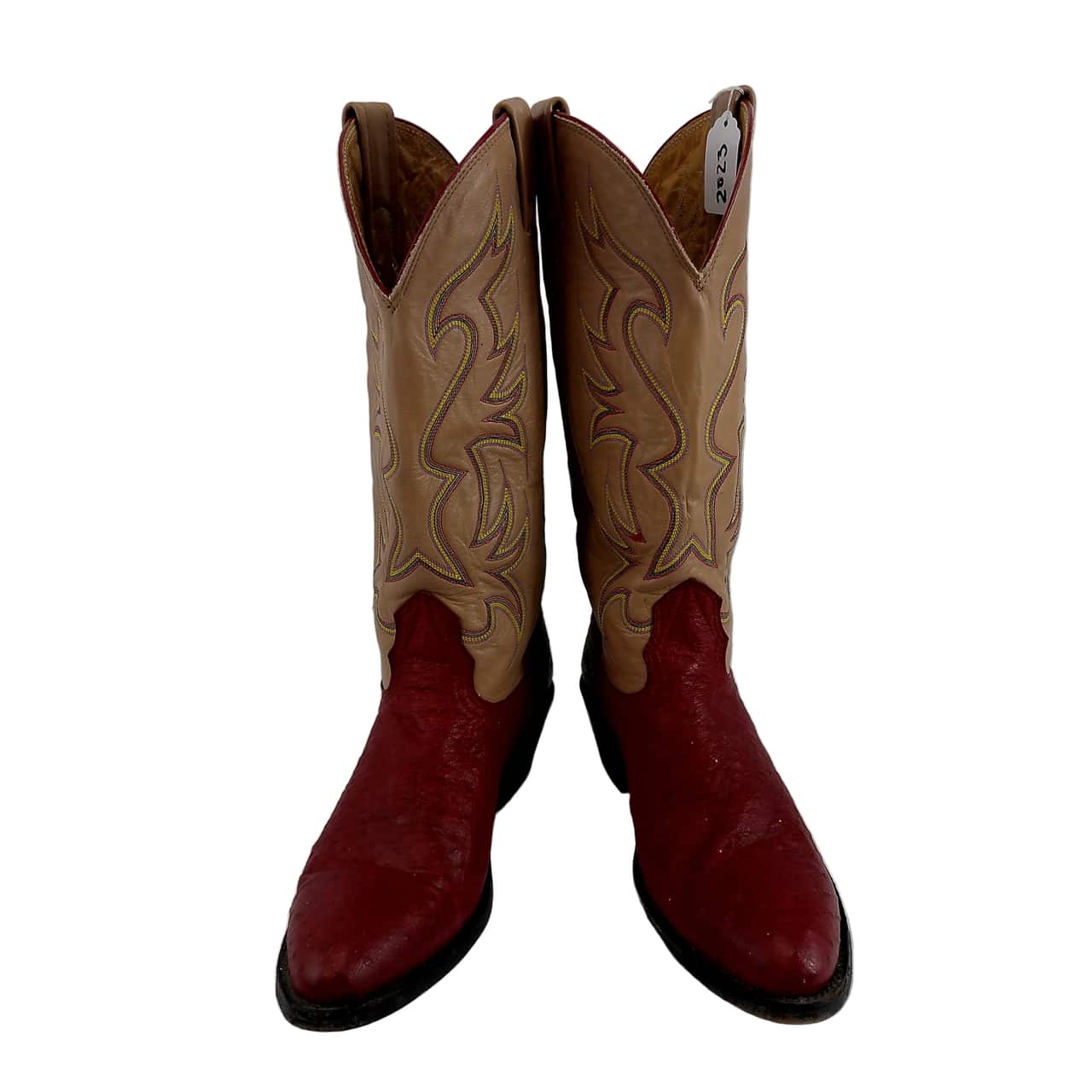 A pair of cowboy boots with tan shafts featuring light tan western embroidery and deep red feet, shown against a plain white background.