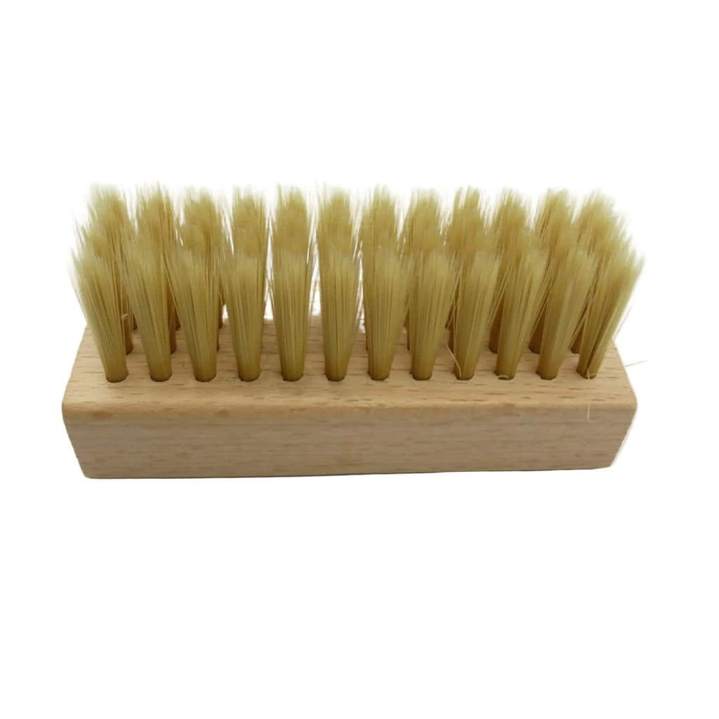 A small rectangular wooden-handled brush with dense natural tan bristles, photographed on a plain white background.