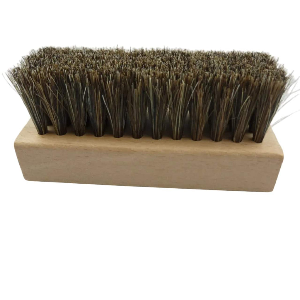 A rectangular hand brush with dark brown natural horsehair bristles and a light tan wooden handle, shown on a plain white background.