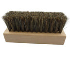 A rectangular hand brush with dark brown natural horsehair bristles and a light tan wooden handle, shown on a plain white background.