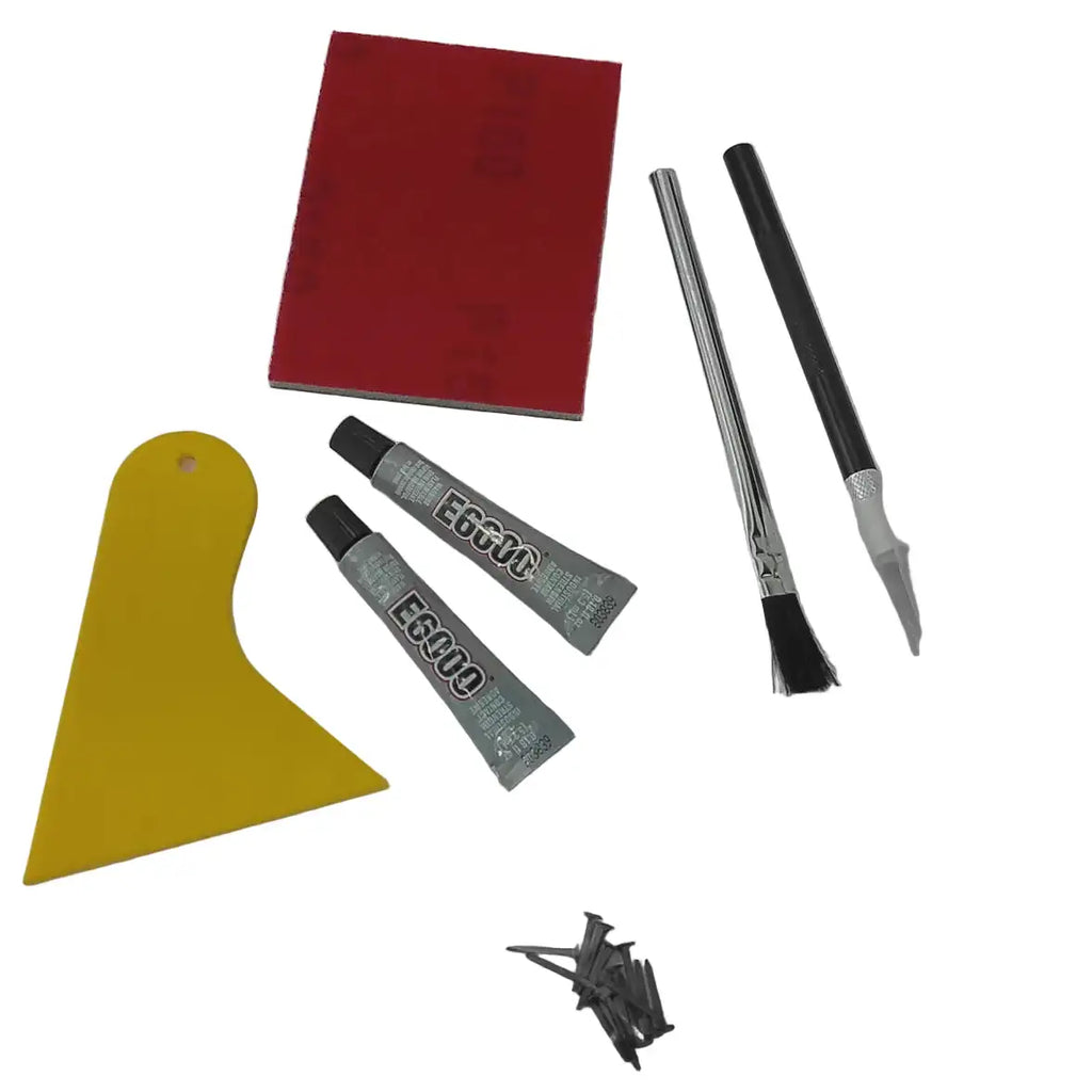 A DIY cowboy boot heel repair kit laid out on a light gray background, containing a sanding sheet, two silver tubes of adhesive, a yellow plastic scraper, glue brush, craft knife, and a small bag of shoe nails from Boot Collector.