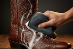 Boot care drying cloth being used on hand-tooled boots to dry foam leather soap on www.bootcollector.com