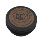 A round black metal tin with a brown circular label on top, photographed on a plain white background. The label reads 'LEATHER NOURISHER' and shows a central 'BC' logo with 'Bootcollector.com' beneath it.