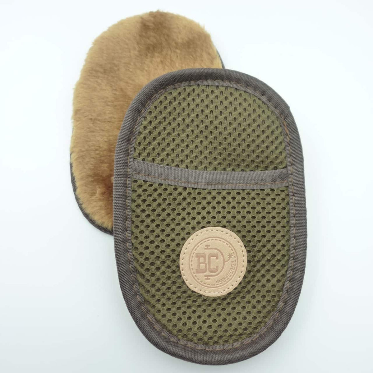 A close-up of a mesh-covered mitt with a deep pile side and dark brown fabric border and a circular tan Boot Collector logo patch.