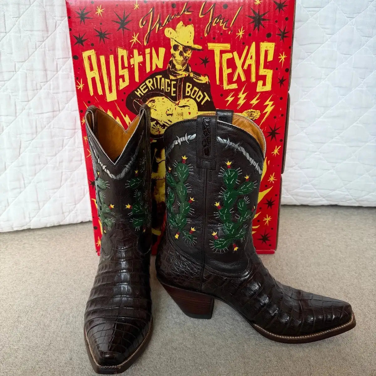 A pair of women's caiman leather boots with cactus detail on shaft