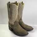 A pair of western cowboy boots in a distressed taupe-brown leather, featuring decorative embroidered stitching in tan and light green, set against a plain light gray background.