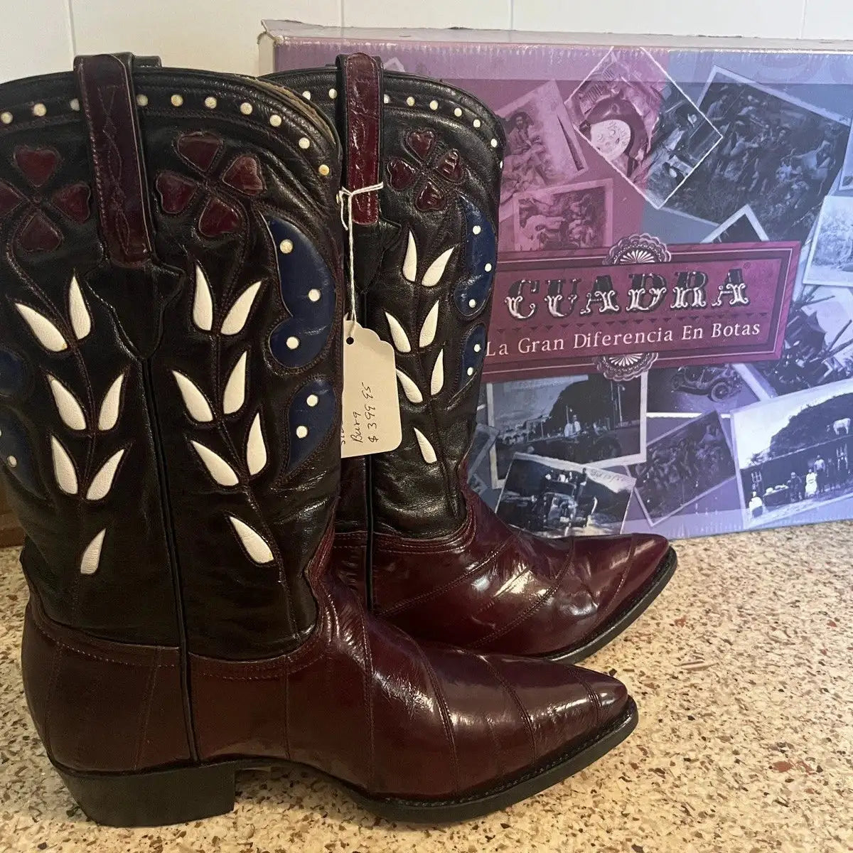 A pair of maroon eel cowboy boots with white and blue inlay